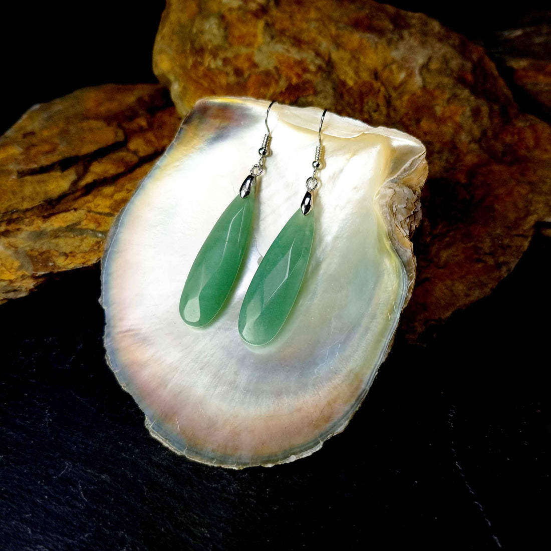 Groene edelstenen oorbellen met aventurien en sterling zilver (925) liggend in witte schelp | Big Long Drop Green Aventurine