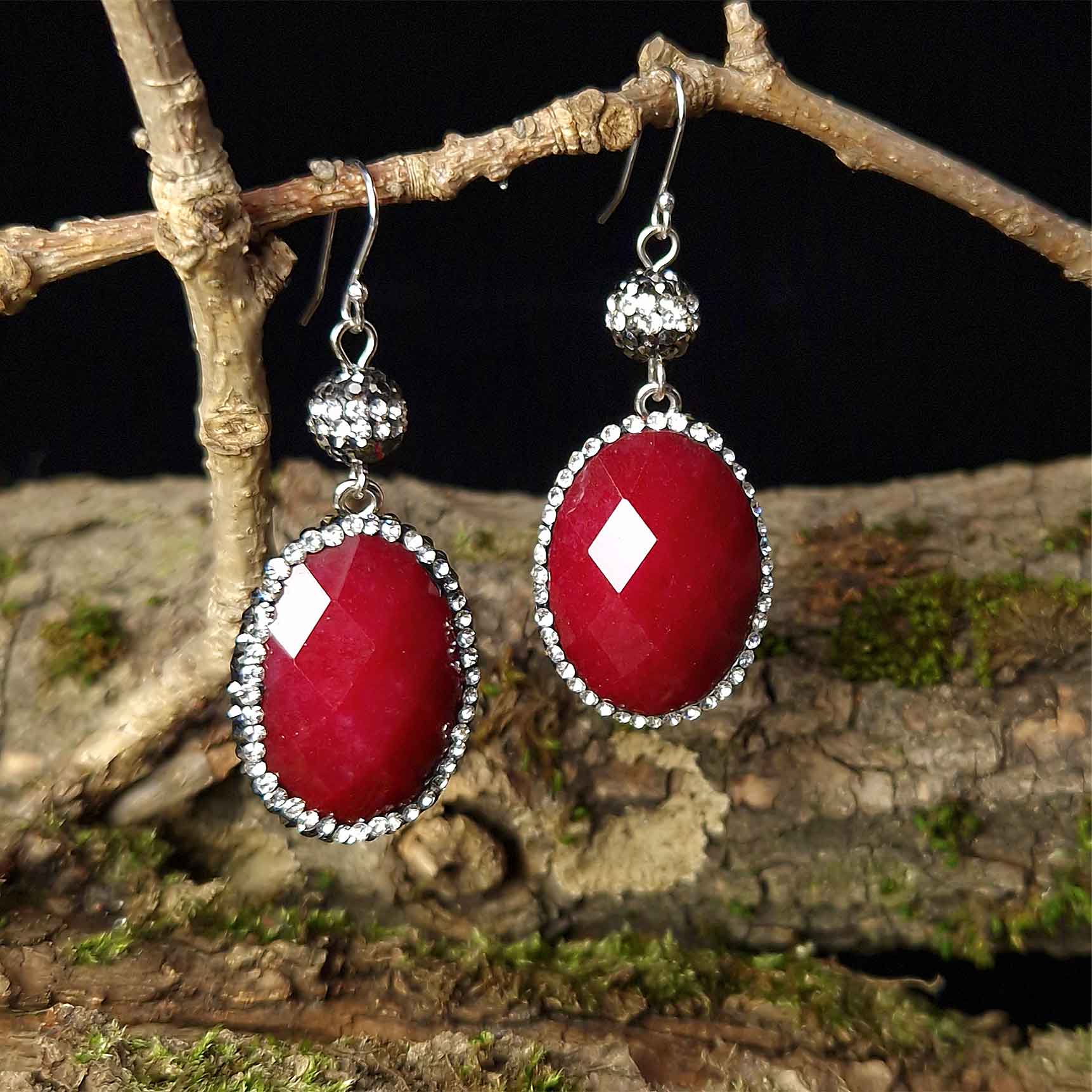 Rode edelstenen oorbellen met jade, stras steentjes en sterling zilver (925) hangend aan tak vooraanzicht | Bright Red Jade Oval