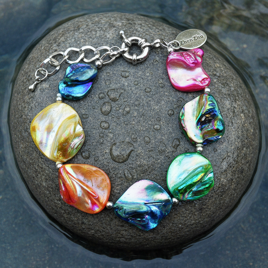 Kleurrijke parelmoer schelp armband op natte grijze steen in meertje