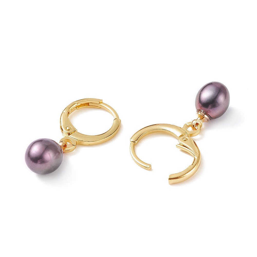 Zoetwater parel oorbellen met goud edelstalen oorringen liggend | Dilia