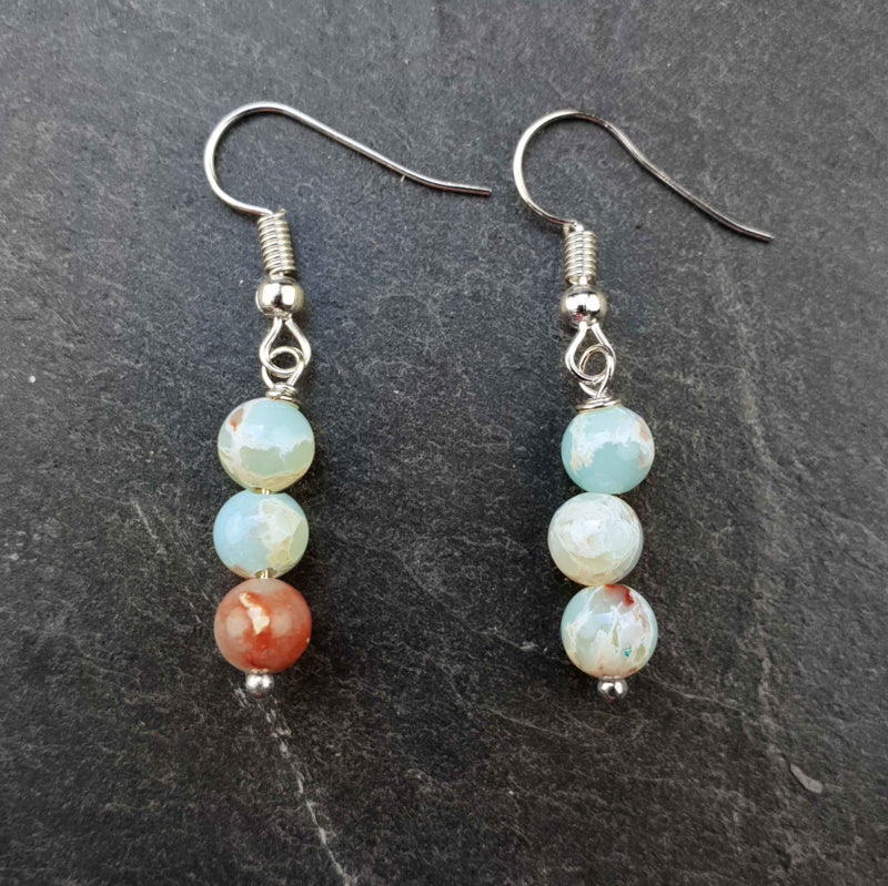 Licht blauwe edelstenen oorbellen met Shoushan en sterling zilver (925) liggend op leisteen | Shoushan