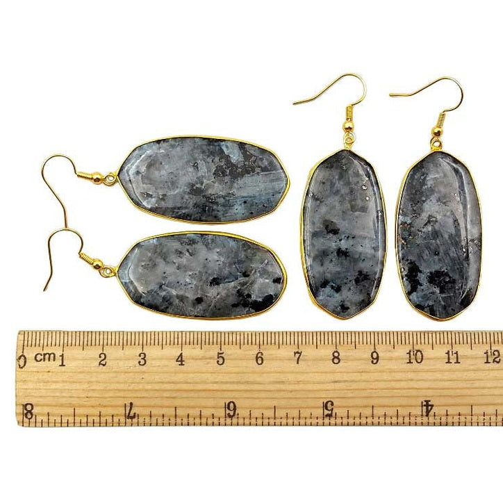 Grote edelstenen oorbellen met zwarte labradoriet en goud edelstaal liggend naast lineaal | Big Black Labradorite Gold