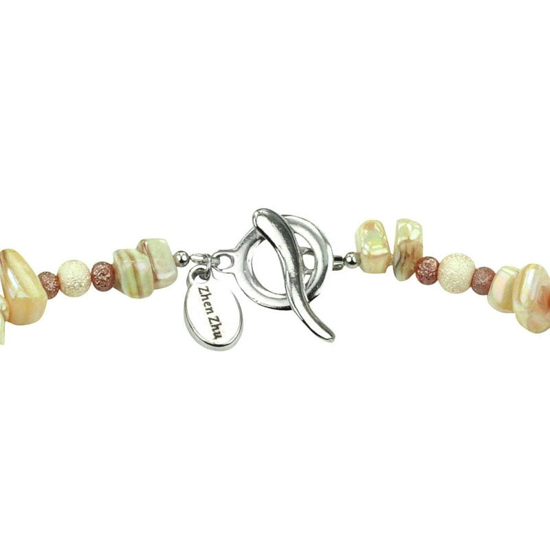 Slotje van cremè kleurige parelmoeren ketting | Cube Glas