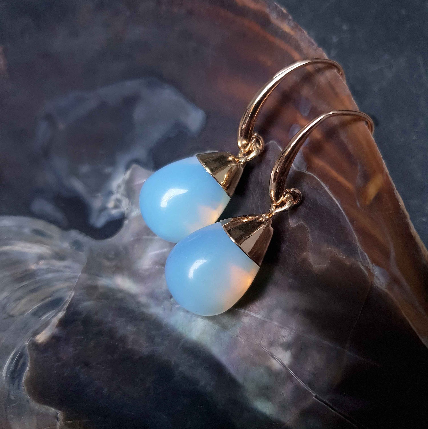 Blauwe edelstenen oorbellen met opaal liggend in schelp | Gold Dip Sea Opal