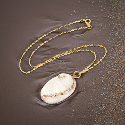 Witte schelpen ketting liggend op nat strand | White Shell Gold
