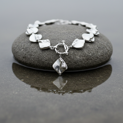 Zilver gekleurde parelmoeren schelpen ketting met hanger liggend op steen in water | Shell Silver