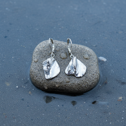 Zilver gekleurde schelpen oorbellen liggend op steen in water | Shell Silver