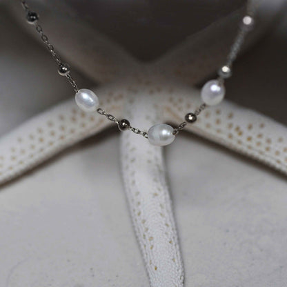 Witte zoetwater parelketting met zilver edelstaal hangend voor zeester | Parelketting Eline Zilver