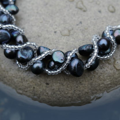 Zoetwater parel armband met blauw zwarte parels liggend op steen in water close up | Veronica