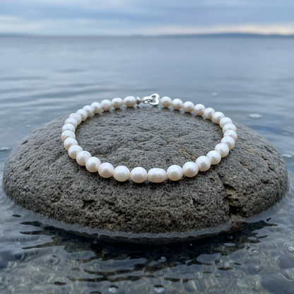 Handgeknoopt parelketting met witte parels liggend op een steen | Parelketting Big Round pearl