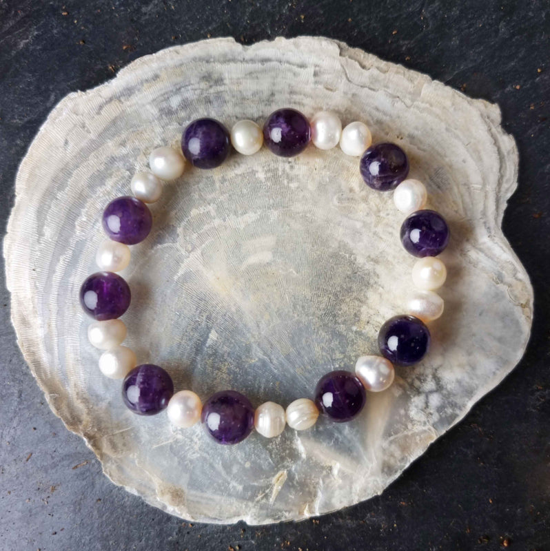 Zoetwater parel armband met witte parels en paarse edelsteen amethist liggend op witte schelp | Pearl Amethyst
