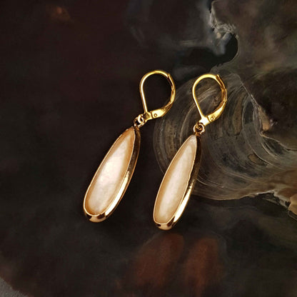 Beige parelmoeren oorbellen met goud kleurig edelstaal liggend in schelp | Oblong Drop Beige