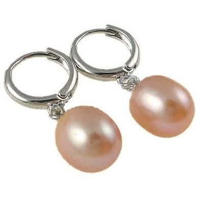 Zoetwater parel oorringen met zalm kleurige parels en zilver edelstaal liggend | Zente