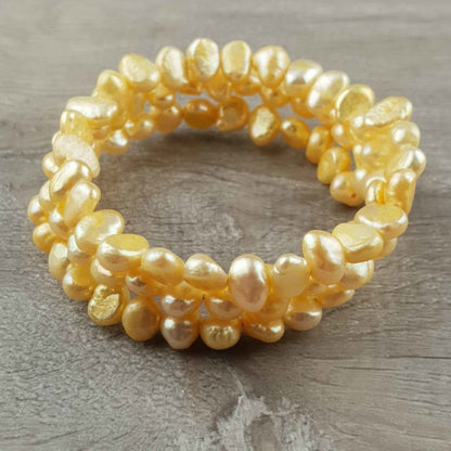 Zoetwater parel wikkel armband met gele parels liggend op hout | Zen Yellow